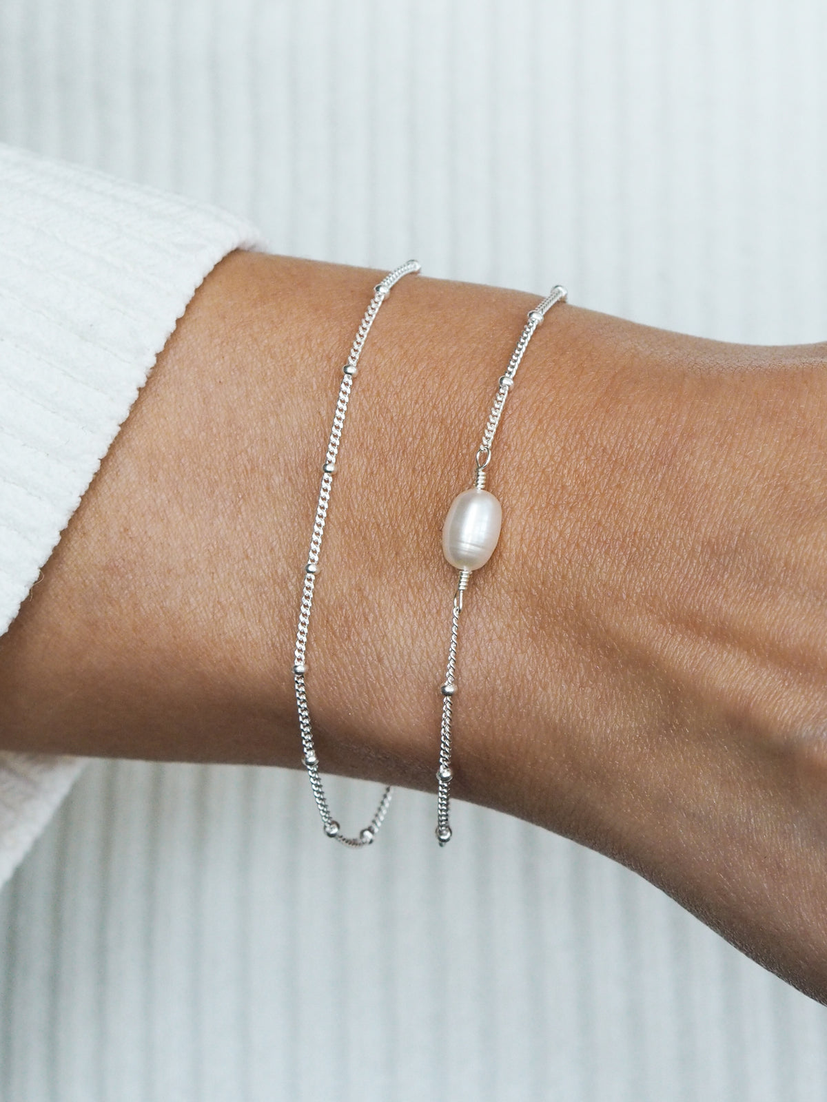 Silver pearl bracelet styled on wrist, perfect as a delicate bridesmaid gift from Aluna Mae.