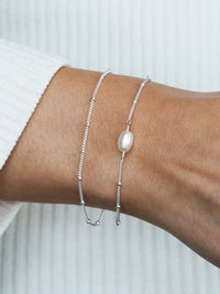 Silver pearl bracelet styled on wrist, perfect as a delicate bridesmaid gift from Aluna Mae.