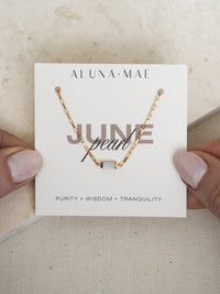 June birthstone bracelet featuring a rectangular mother of pearl stone on a radiant 18ct gold plated box chain, displayed on an Aluna Mae birthstone card.